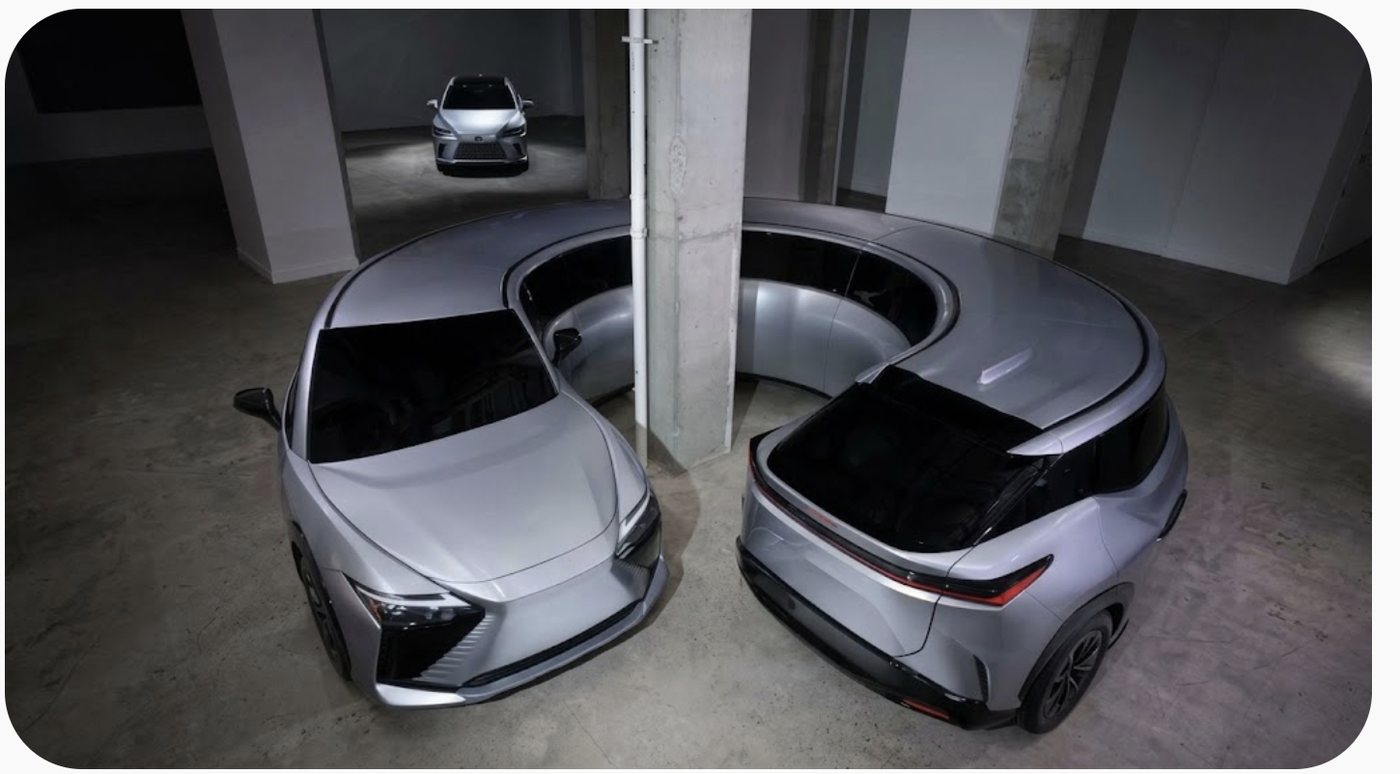 A car in a bare garage with its bonnet and boot open