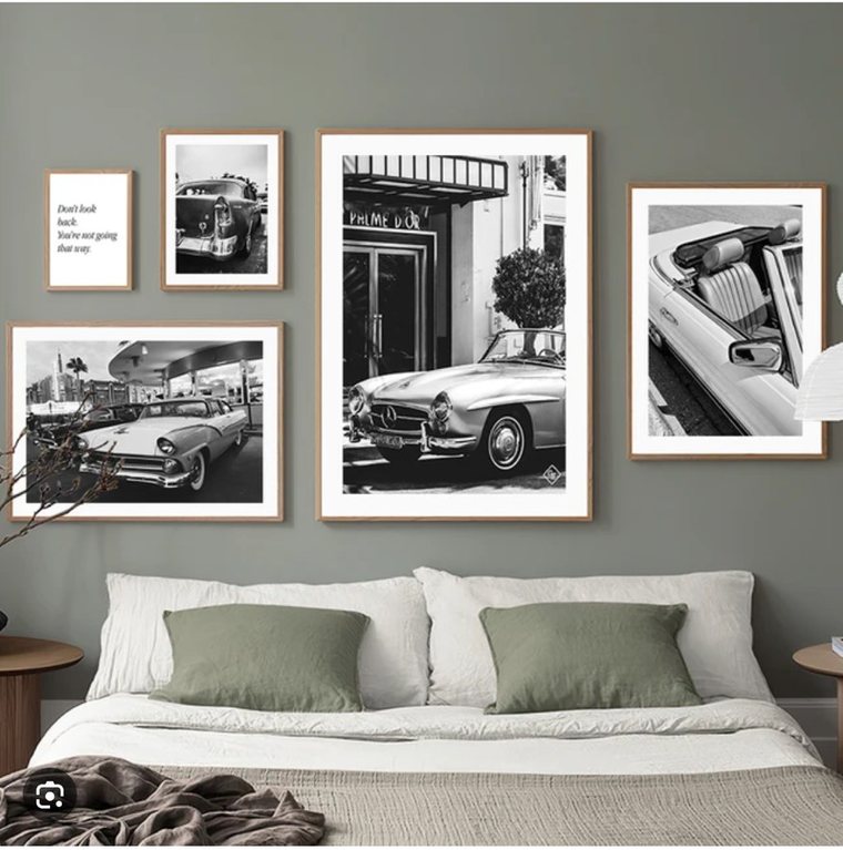 A club bedroom hung with framed motoring photographs