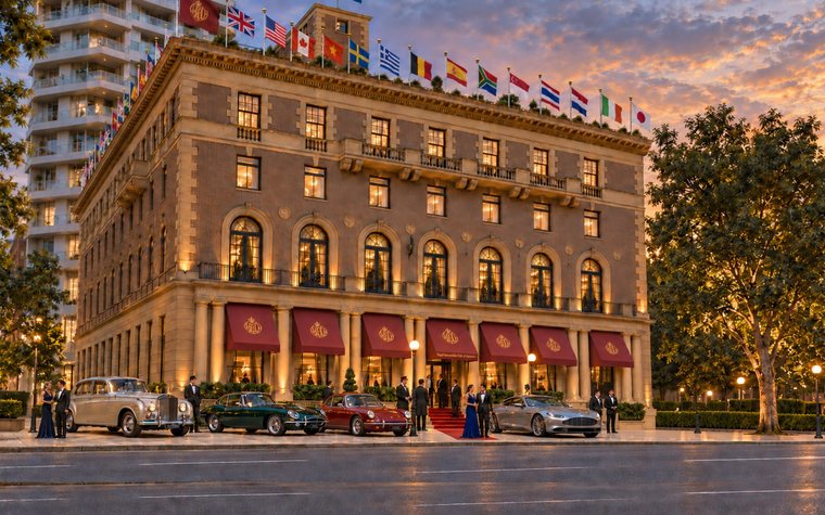 The clubhouse at 89 Macquarie Street at dusk, flags flying from the rooftop