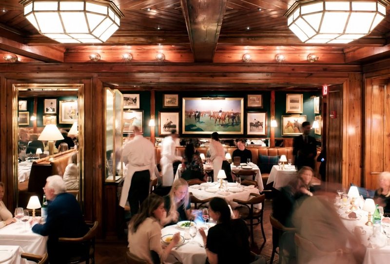 A busy wood-panelled brasserie, every table taken