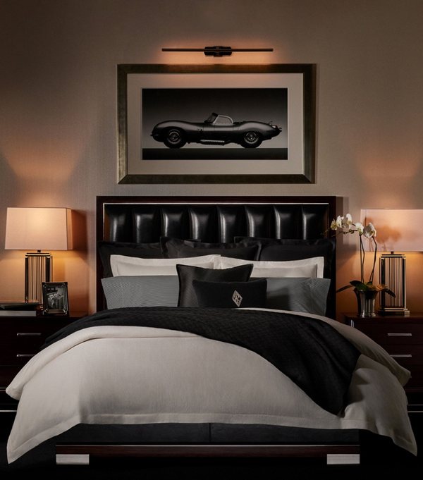A club bedroom with a framed motoring print above the bed